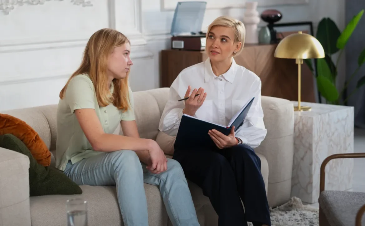 Two people talking in a therapy setting